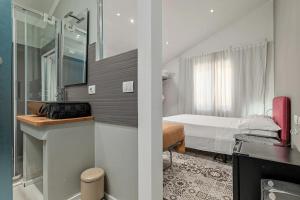 a small room with a bed and a bathroom at Gaias Rooms in Olbia +93 photos