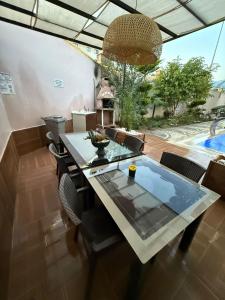 a dining room with a glass table and chairs at kestel city in Alanya