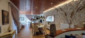 a living room with a table and a stone wall at Gravanis Resort in Sikáminon