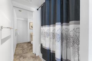 a bathroom with a blue and white shower curtain at The York Suites in Toronto +221 photos