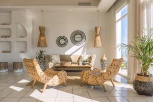a living room with chairs and a couch at Marilena Sea View Hotel in Pyrgi