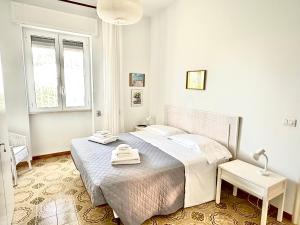 a bedroom with a bed with two towels on it at Villa Oleandera a Polignano a Mare in Polignano a Mare