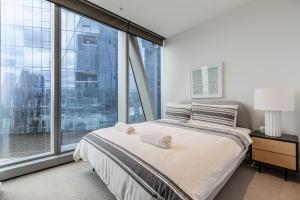 a bedroom with a bed and a large window at Spencer on Rock in Melbourne +39 photos