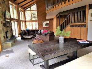 a living room with a table and a couch at 4 Spyglass Lane in Sunriver