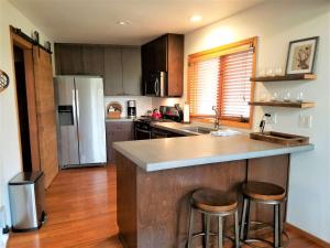 a kitchen with a counter and a refrigerator at 4 Spyglass Lane in Sunriver