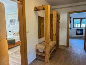a room with a bunk bed and a mirror at Hiša Štanfl in Osilnica