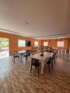 a large room with tables and chairs in it at Pousada Paraiso in Canudos