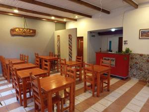 a dining room with wooden tables and chairs at Hotel Munay La Quiaca in La Quiaca