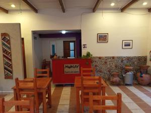 a restaurant with a table and chairs in a room at Hotel Munay La Quiaca in La Quiaca