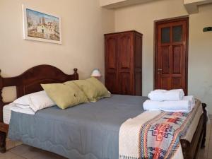 a bedroom with a bed with towels on it at Hotel Munay La Quiaca in La Quiaca
