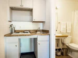 a small bathroom with a sink and a toilet at Tolleson Studio Pool & Gym Access for 2 in Tolleson
