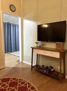 a living room with a flat screen tv on a table at The Haven in Blackall