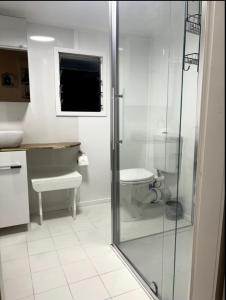 a bathroom with a glass shower and a toilet at The Haven in Blackall +5 photos