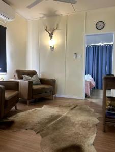 a living room with a couch and a rug at The Haven in Blackall