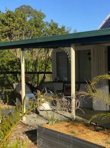 a person sitting on the porch of a house at The Haven in Blackall