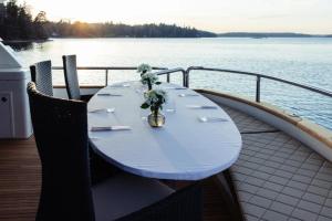 a white table with a vase of flowers on a boat at The Lux Yachts - Luxury Private Yacht Experience in Helsinki