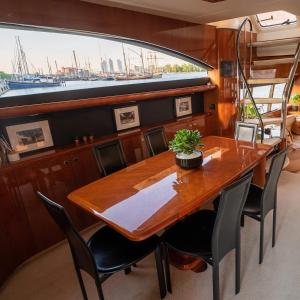 a dining room with a table and chairs in a boat at The Lux Yachts - Luxury Private Yacht Experience in Helsinki