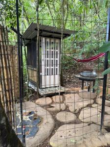 a cage with a bird house in a forest at Eco Meeting in Cali