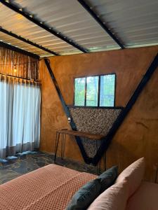 a bedroom with a bed in a room with a window at Eco Meeting in Cali
