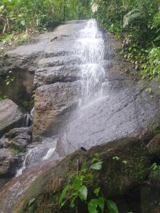 a waterfall on the side of a road at Hostel e Camping Yoshida Naturismus in Ibiúna