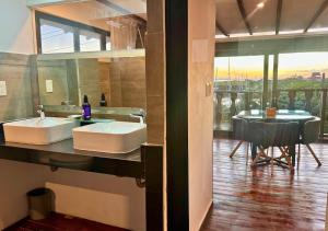 a bathroom with two sinks and a table with a view at Rico Isla Rooms Eco-Chic in Isla Mujeres +64 photos