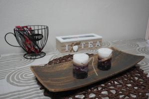 two glasses of beer on a tray next to a box at Prishtina Center Apartment, 100m from Skanderbeg Square in Prishtinë