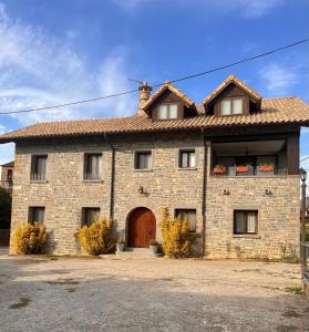 a large brick house with a brown door at HOTEL RURAL Casa Campo in Abay