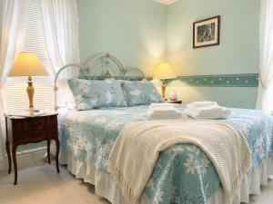 a bedroom with a bed with two towels on it at Strathaird Bed and Breakfast in Niagara Falls