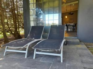 two chairs sitting in front of a house at Gala Da Vittoria in Capelas