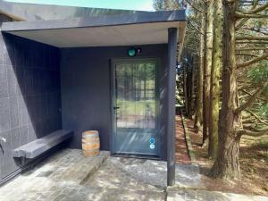 a house with a blue door and a bench at Gala Da Vittoria in Capelas +3 photos