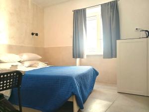 a bedroom with a blue bed and a window at Terrazza Cristallini Napoli in Naples