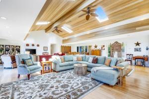 a living room with a blue couch and chairs at Voyagers Paradise in Gualala