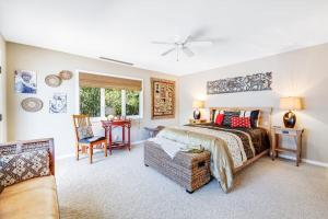 a bedroom with a bed and a table and a chair at Voyagers Paradise in Gualala