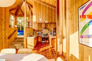 a kitchen in a wooden cabin with a table and chairs at Breakers Hideaway in Sea Ranch