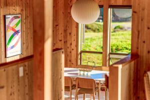 a dining room with a table and chairs and windows at Breakers Hideaway in Sea Ranch +15 photos