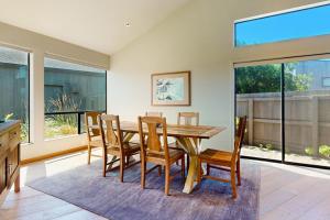a dining room with a wooden table and chairs at West Meadow in Sea Ranch