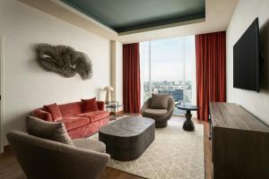 a living room with a red couch and two chairs at The Westin Nashville in Nashville