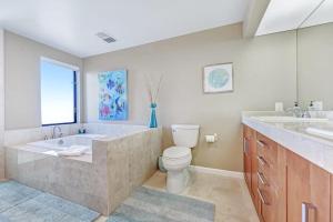 a bathroom with a tub and a toilet and a sink at Del Mar Point in Sea Ranch +28 photos