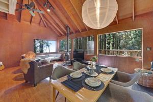 a living room with a table and some chairs at Cabin 55 in Sea Ranch