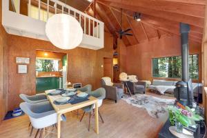 a living room with a table and a fire place at Cabin 55 in Sea Ranch