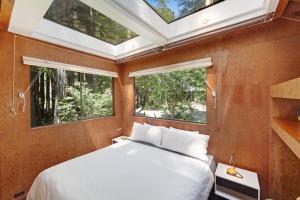 a bedroom with a bed and two windows at Cabin 55 in Sea Ranch +21 photos