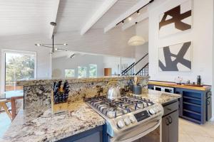 a kitchen with a stove and a counter top at The Great Escape in Sea Ranch