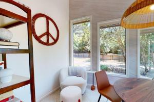 a living room with a table and a chair and a window at The Great Escape in Sea Ranch +38 photos