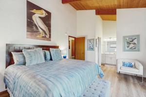 a bedroom with a large bed with a bird on the wall at Sea Raven in Gualala