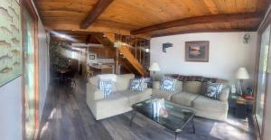 a living room with a couch and a table at Beaver Creek Hideaway in Kenai