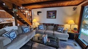 a living room with a couch and a table at Beaver Creek Hideaway in Kenai