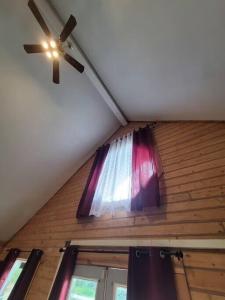 a ceiling fan and a window in a room at Sterling Cabin close to Kenai River in Sterling