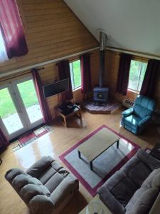 an overhead view of a living room with a couch and chairs at Sterling Cabin close to Kenai River in Sterling +13 photos