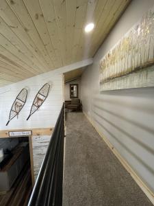 a hallway with a wall with art on it at Catch'em AK - Bears Den in Soldotna