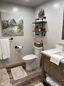 a bathroom with a toilet and a sink at Catch'em AK - Bears Den in Soldotna +12 photos